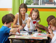 children-painting-together-with-nursery-teacher-in-a-kindergarten